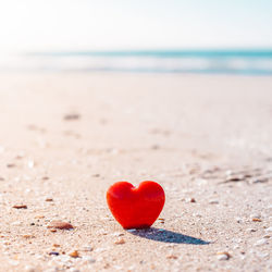 Red heart shape on beach