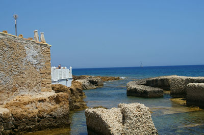 Scenic view of sea against clear blue sky