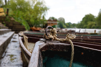 Close-up of boats moored against sky