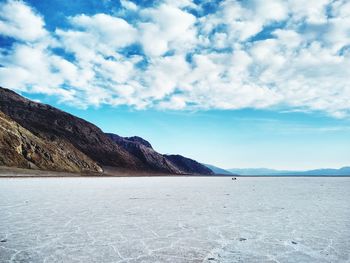 Scenic view of sea and mountains against sky