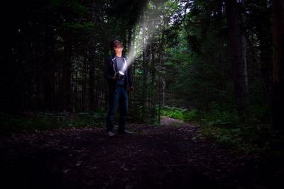 Full length of man standing in forest