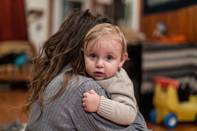 Portrait of cute baby girl with mother