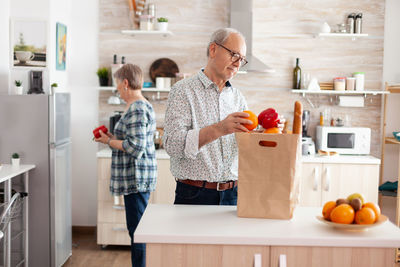 People standing by fruits at home