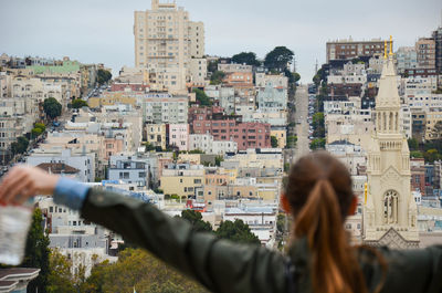Rear view of woman against san francisco cityscape