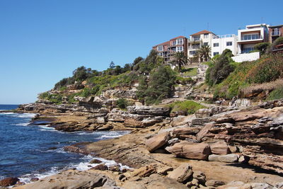 View of built structures against clear blue sky