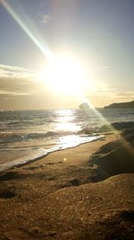 Scenic view of beach against sky during sunset