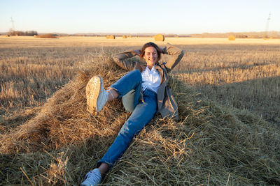 The concept of livestyle outdoor in autumn. close up of a young woman student in a warm 