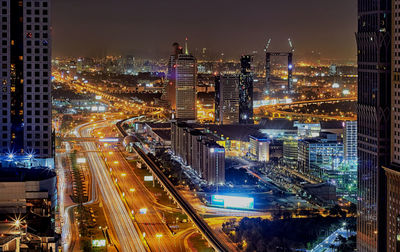 Aerial view of city lit up at night