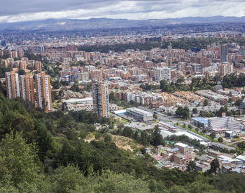 High angle view of city buildings against sky