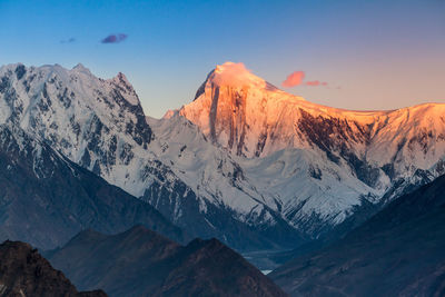 Scenic view of snowcapped mountains against sky during sunset