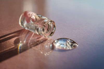 A bottle of cosmetic gel on a pink background.