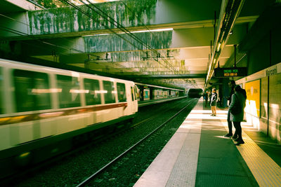 People walking on railroad station platform