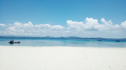 Scenic view of sea against blue sky