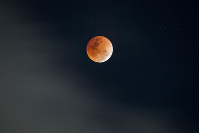 Low angle view of moon against clear sky at night