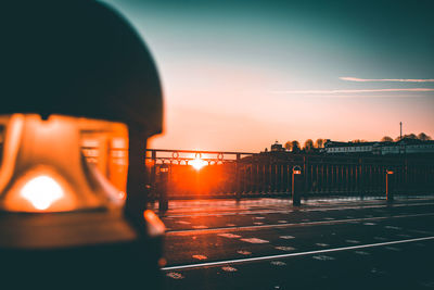 Close-up of illuminated electric light against sky during sunset