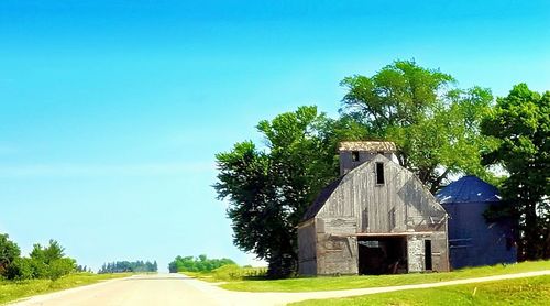 Empty road along built structures