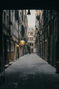 Empty alley amidst buildings in city