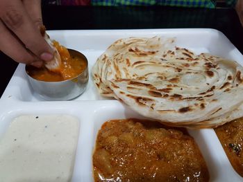 Midsection of man preparing food in plate