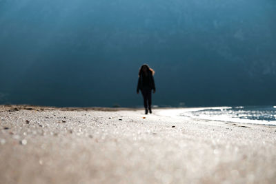 Full length of woman standing on beach