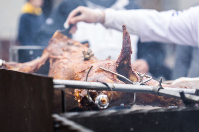 Close-up of hands on barbecue grill