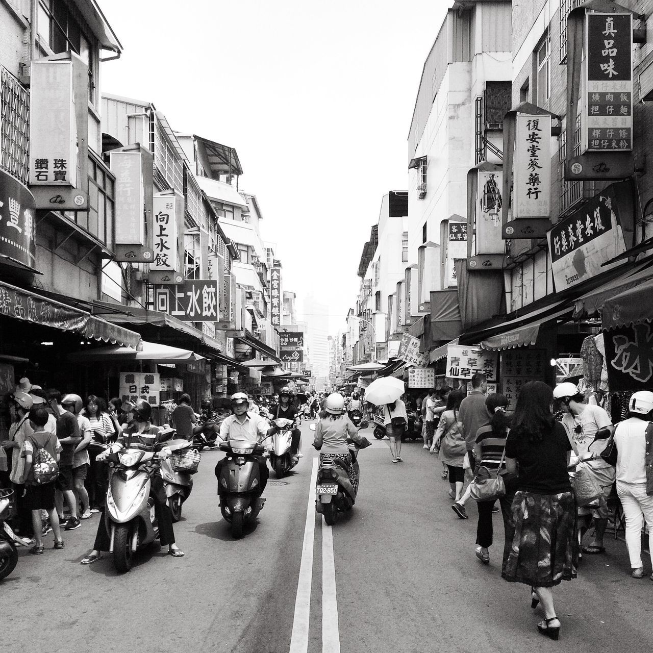 building exterior, architecture, large group of people, built structure, street, city, person, men, city life, walking, lifestyles, transportation, city street, road, leisure activity, mixed age range, market, the way forward, residential structure