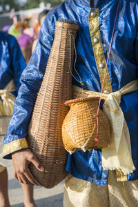 Midsection of man in traditional clothing standing outdoors