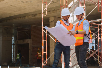 Low angle view of man standing at construction site