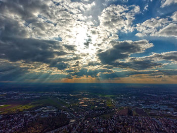 Aerial view of city buildings against sky during sunset