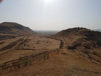 Scenic view of arid landscape against clear sky