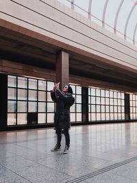 Full length of man standing on bridge against sky