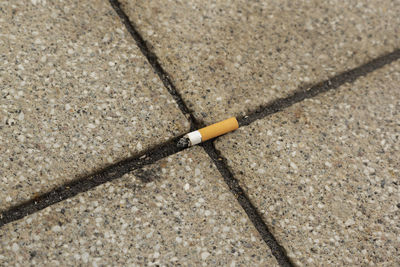 High angle view of cigarette butt on street
