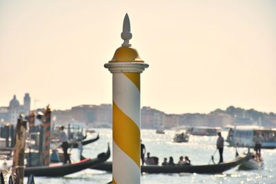 View of buildings at seaside during sunset