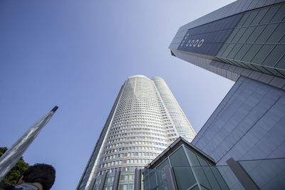 Low angle view of modern building against blue sky