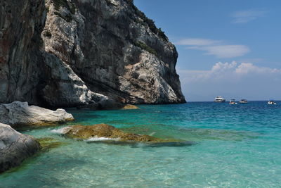 Scenic view of rocks in sea against sky