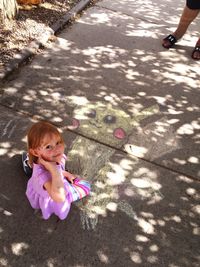 High angle view of girl playing on street