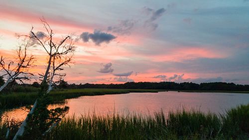 Scenic view of lake against sky during sunset