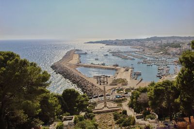 High angle view of buildings by sea against sky