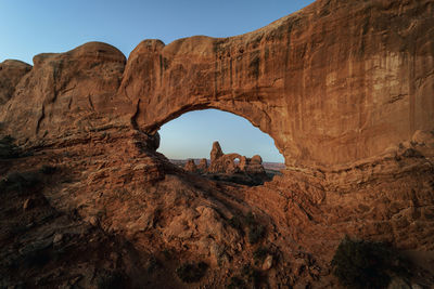 Geological formation view through north window arch to turret arch, arches national park, moab, utah