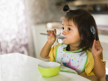 Girl eating at table