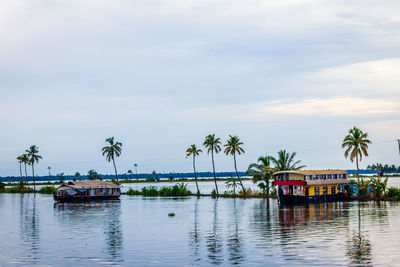 Boats in river against sky