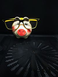 Close-up of toy car on table against black background