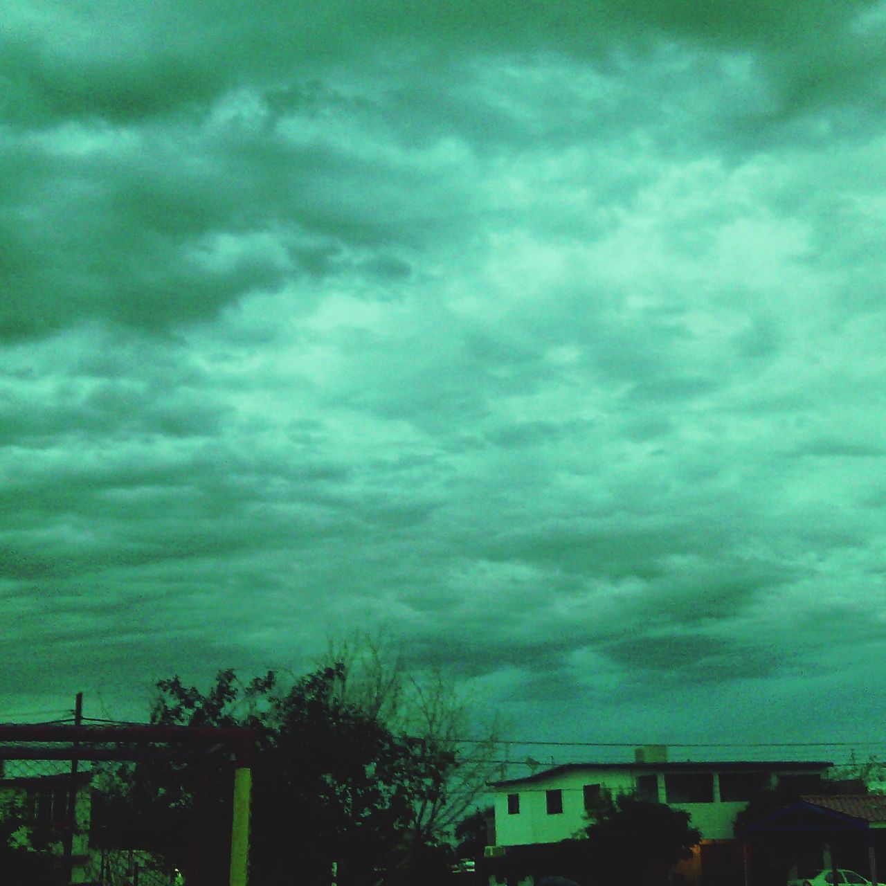 sky, cloud - sky, cloudy, weather, low angle view, storm cloud, built structure, overcast, building exterior, architecture, cloud, tree, dramatic sky, cloudscape, nature, beauty in nature, dusk, atmospheric mood, house, outdoors