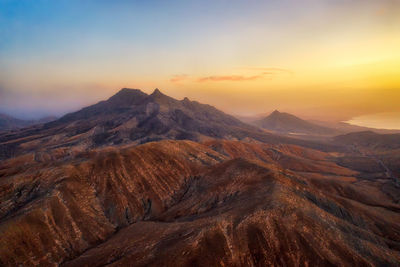 Scenic view of mountains against sky during sunset