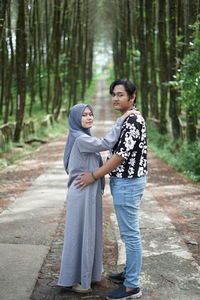 Young couple standing in forest