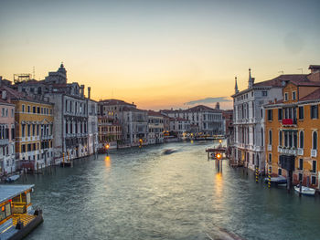 View of buildings in city at sunset