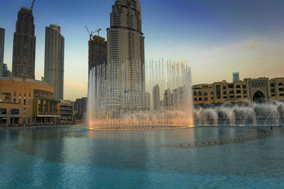 Buildings in city at sunset