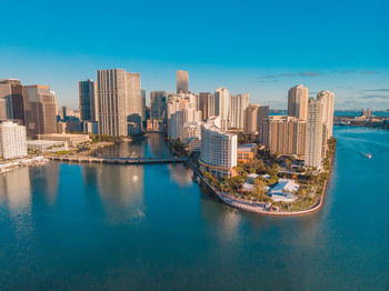 Cityscape by sea against sky