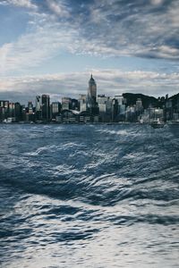 Scenic view of sea and buildings against sky