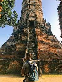 Full length of senior man outside temple against building