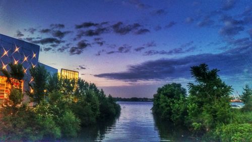 Scenic view of river against cloudy sky